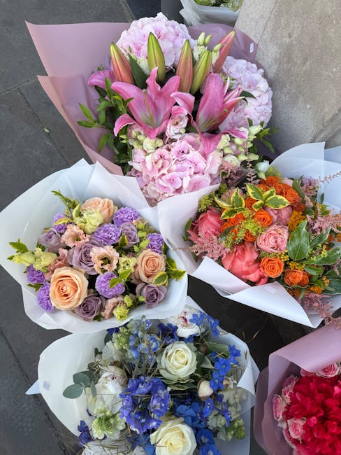 A collection of five vibrant floral bouquets arranged for flower delivery near Cambridge Heath station. The central bouquet features a mix of pink lilies, soft pink hydrangeas, and green foliage, wrap